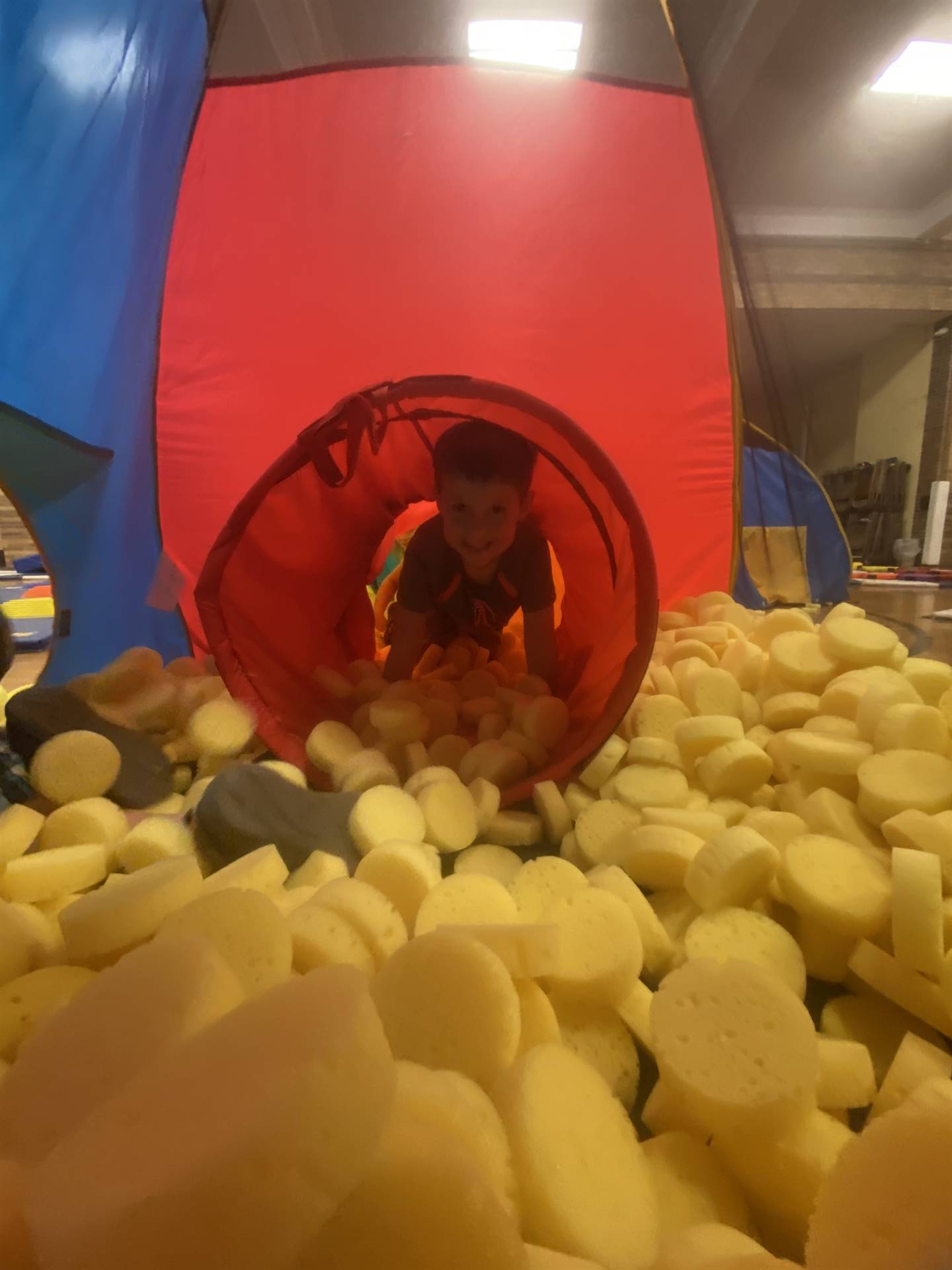 student in yellow ball pit