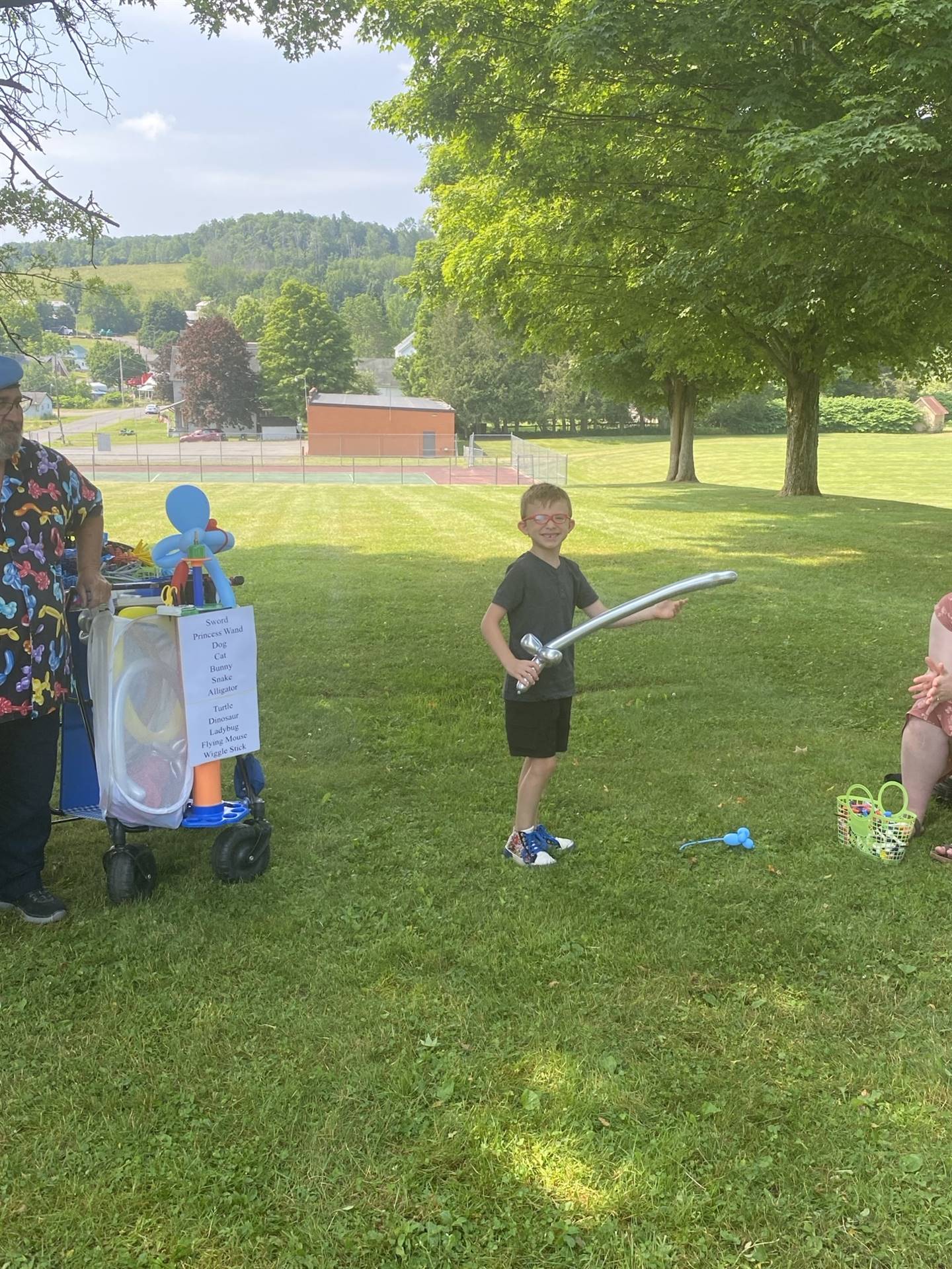 a child holds his balloon sword.