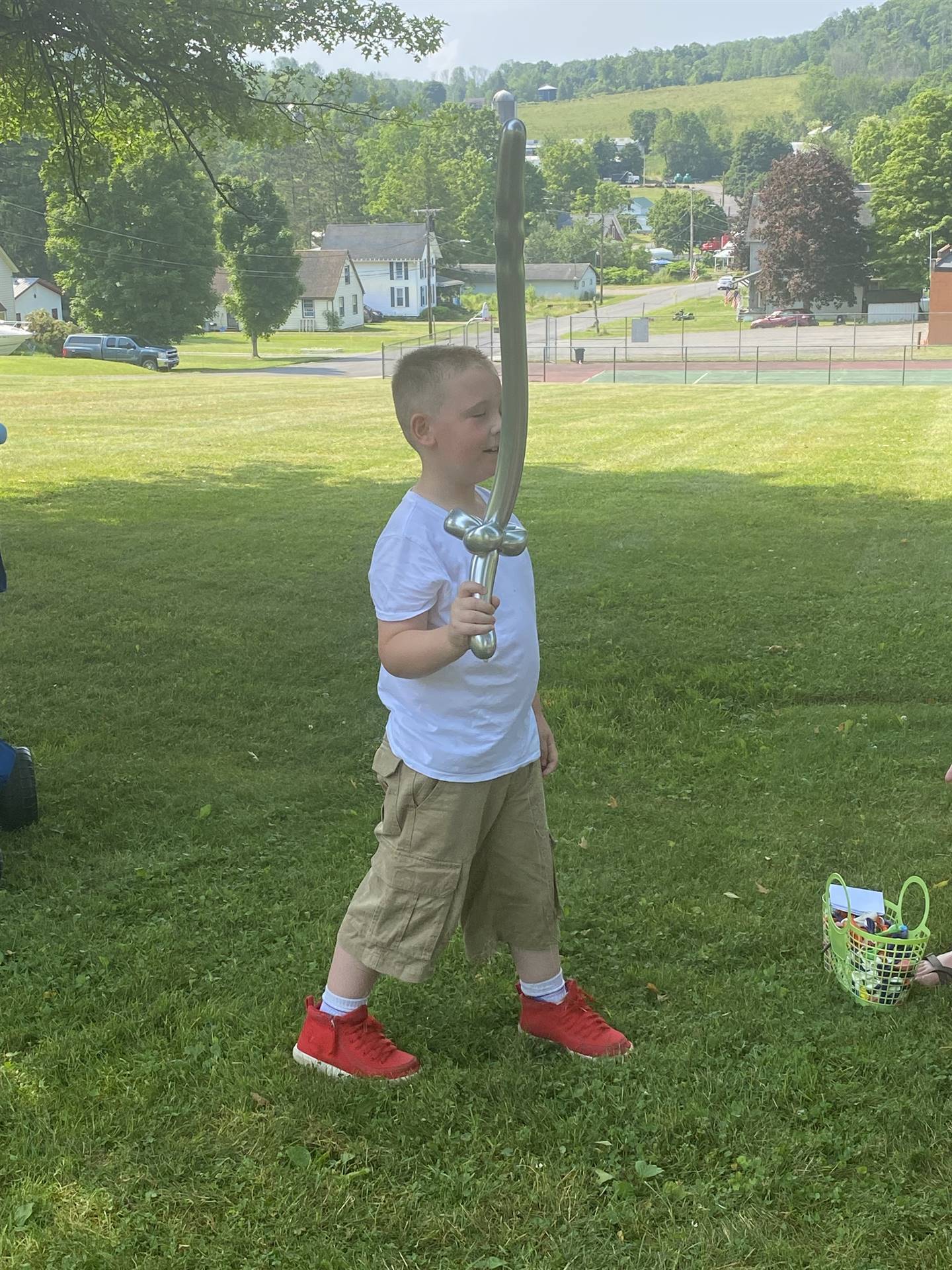 a child holds his balloon sword.