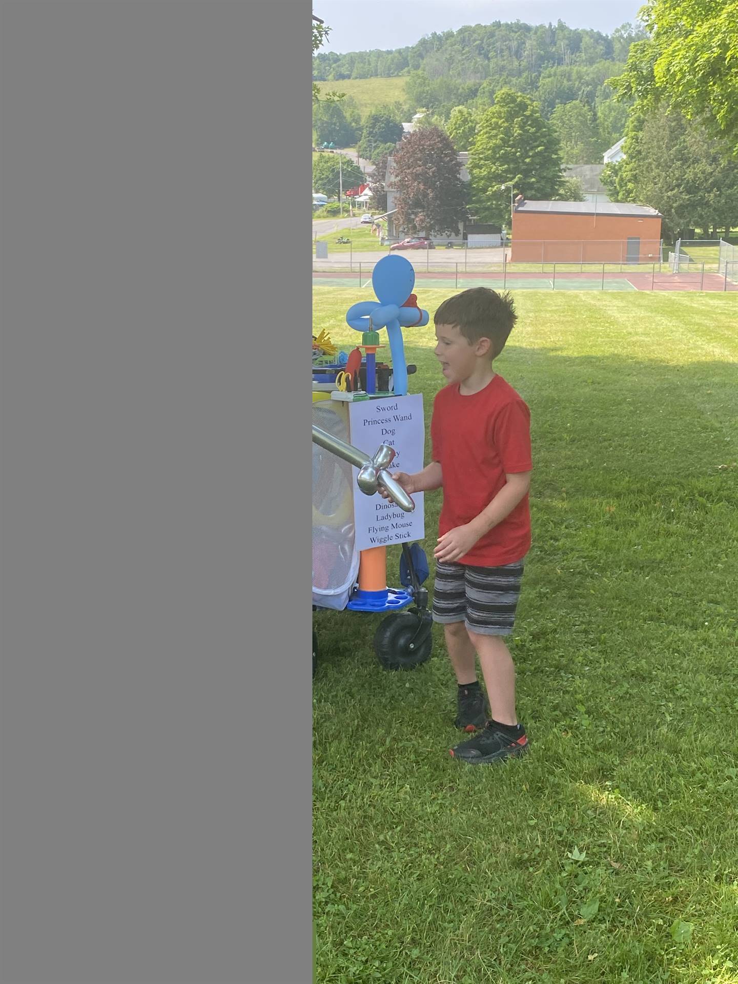 a child holds his balloon sword.