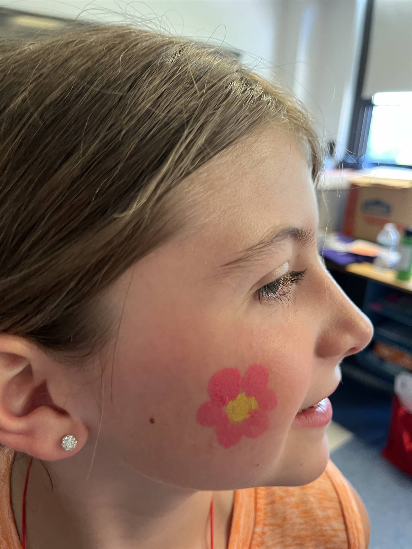 student with pink flower on her cheek