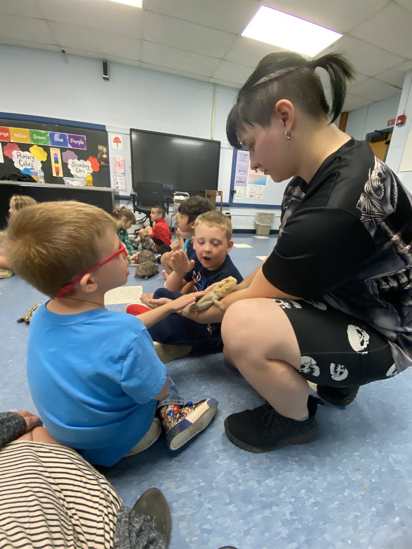 students look and touch a reptile