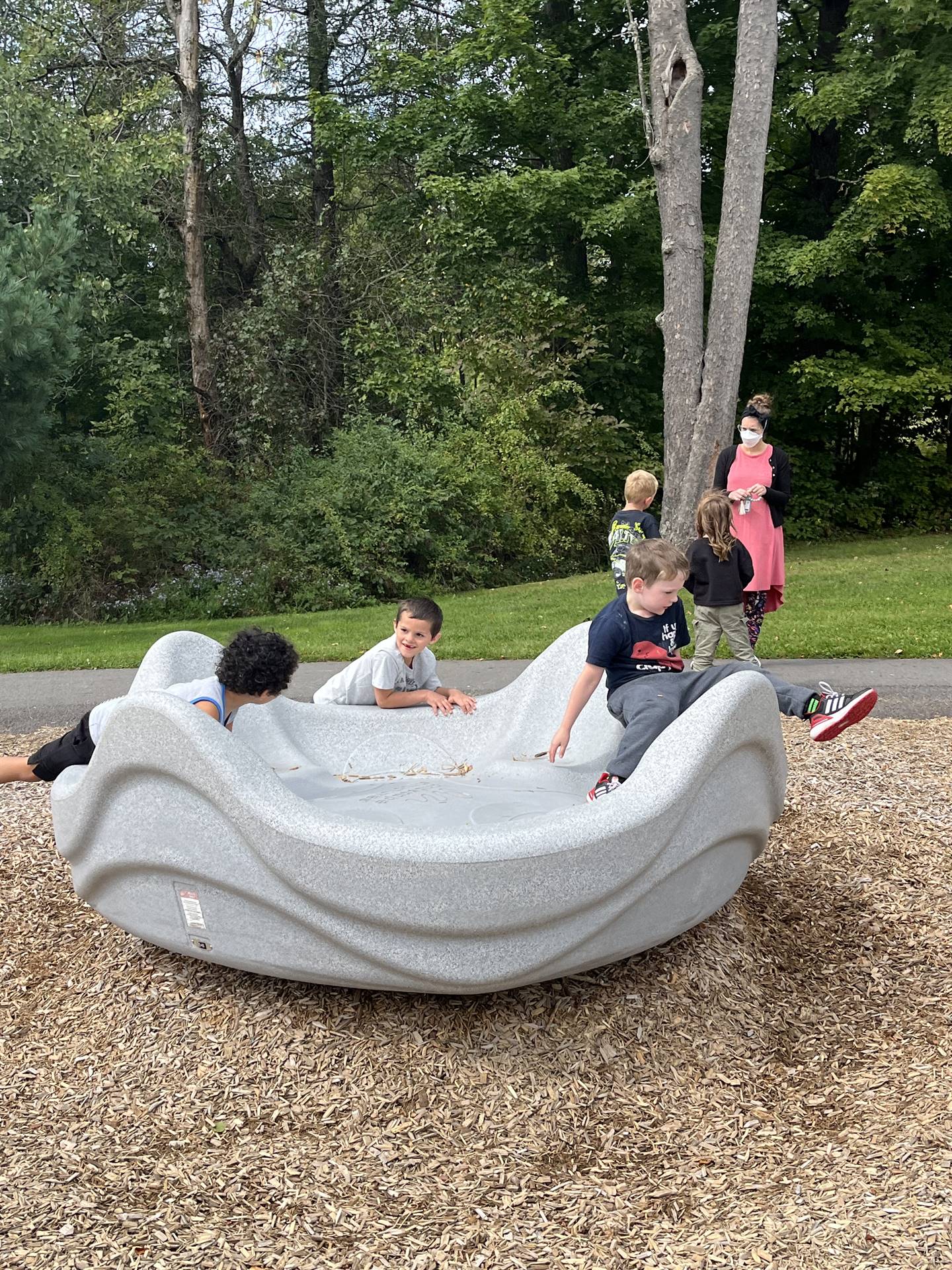 students on a big playground toy