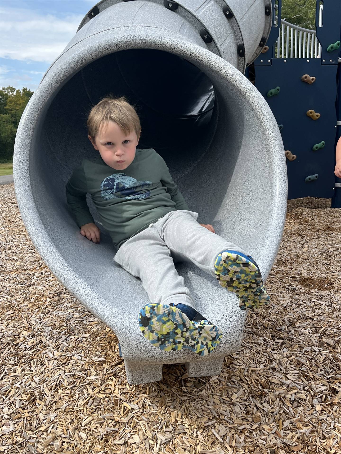 student sliding out of a slide