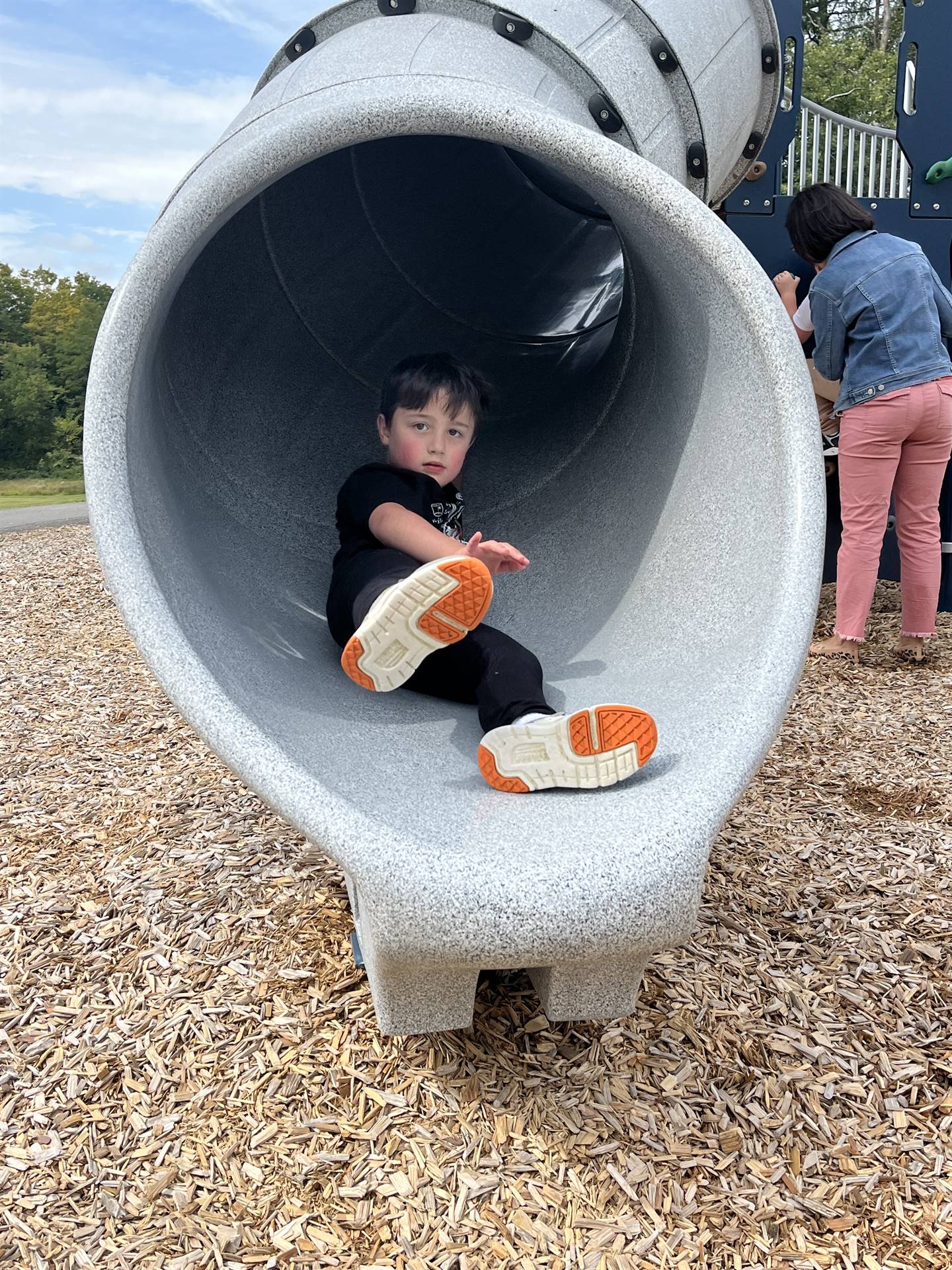 student sliding out of a slide