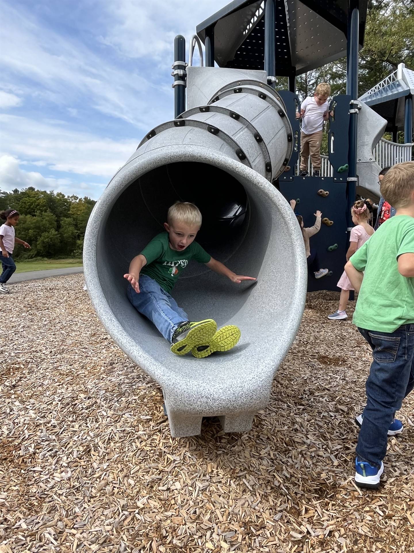 student sliding out of a slide