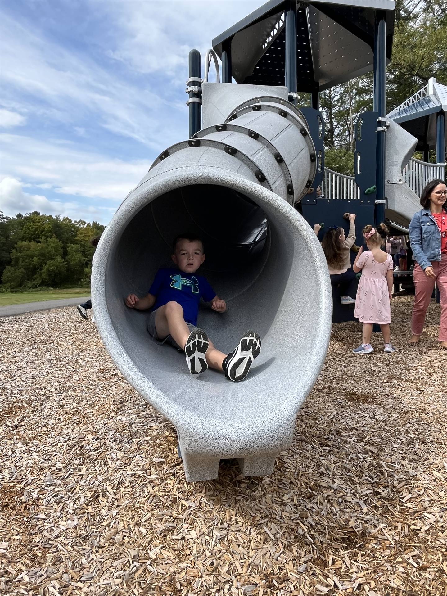 student sliding out of a slide