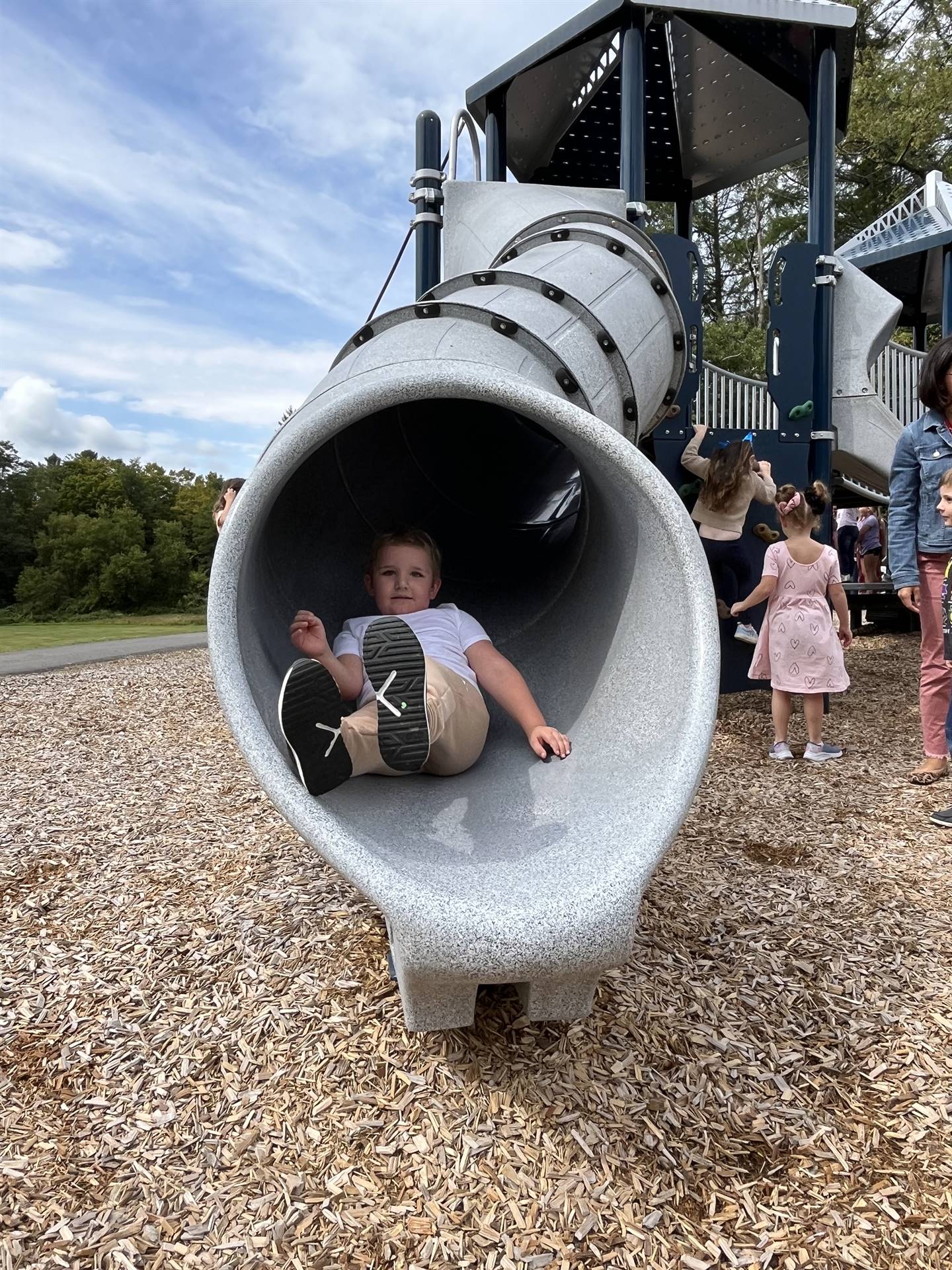 student sliding out of a slide