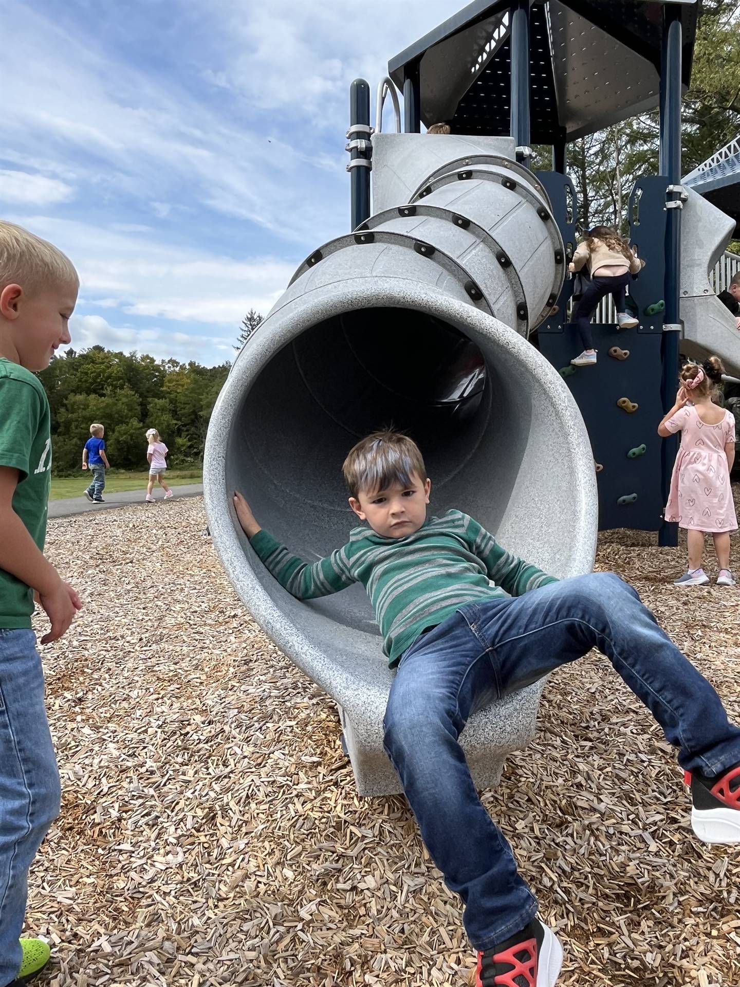 student sliding out of a slide