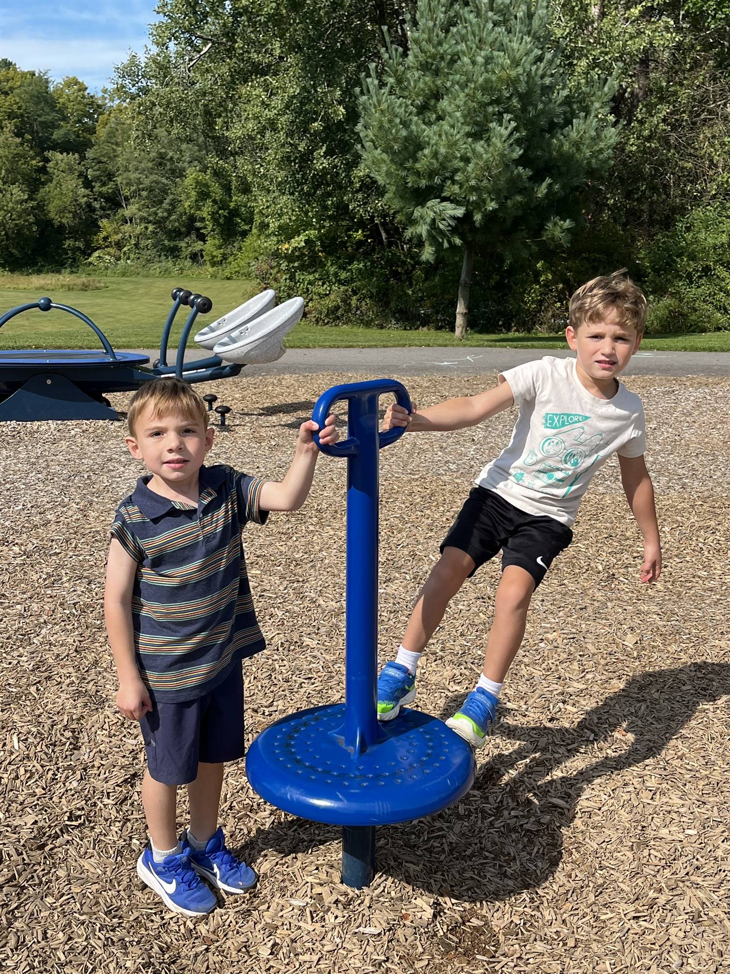 2 students holding a playground spinner