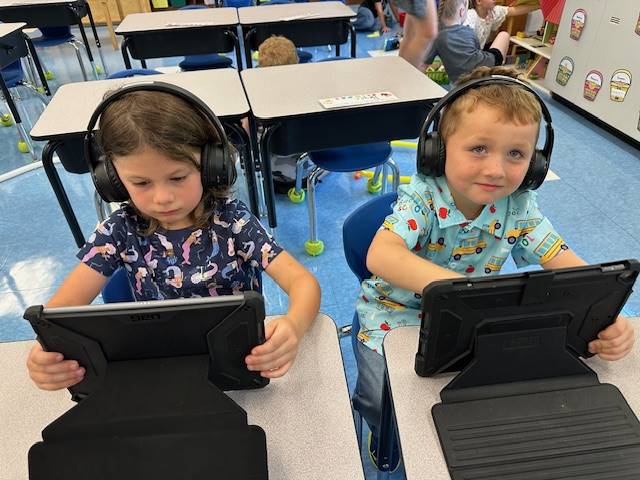 2 students in iPads.