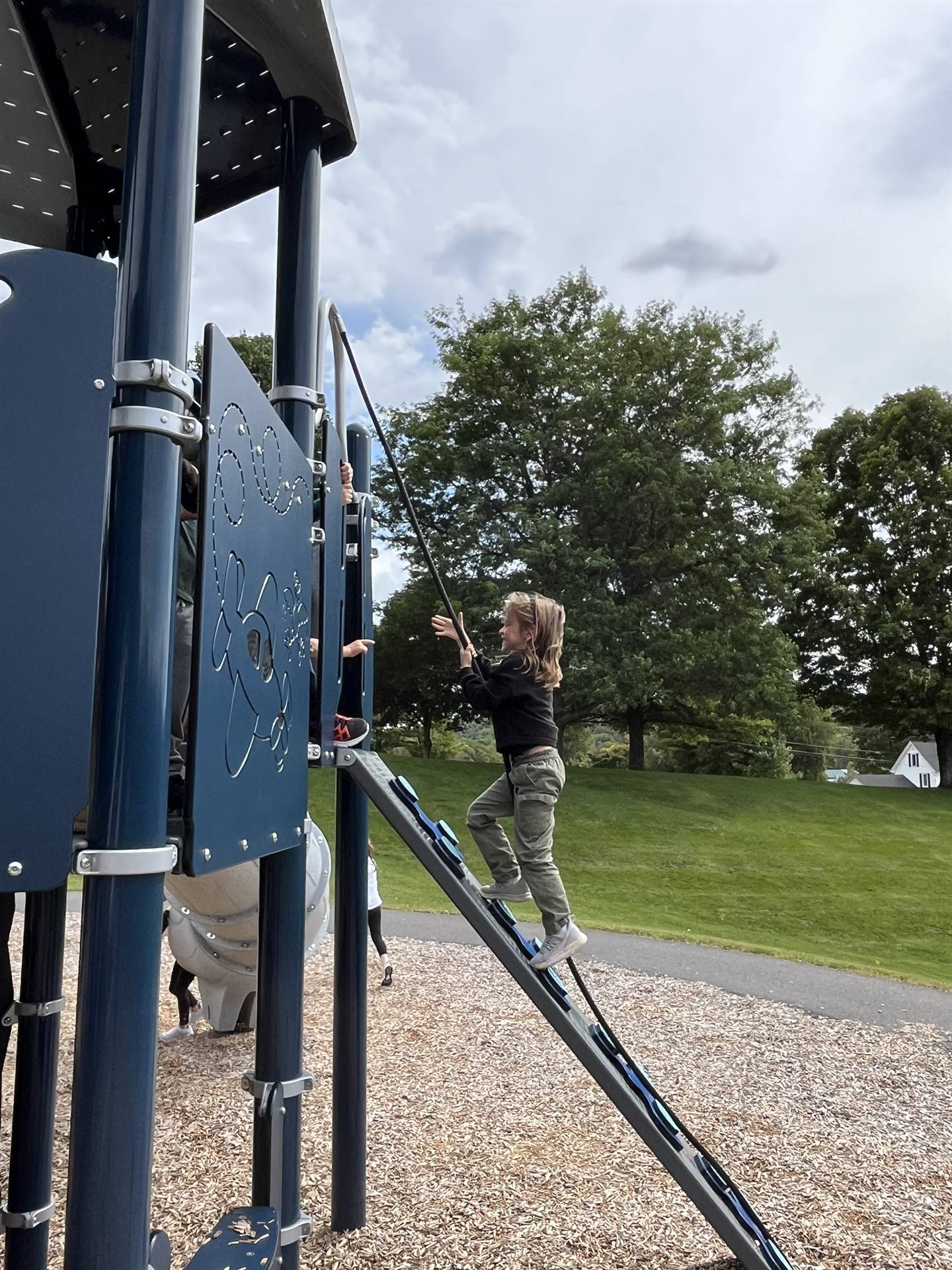 student climbing up ladder on playground