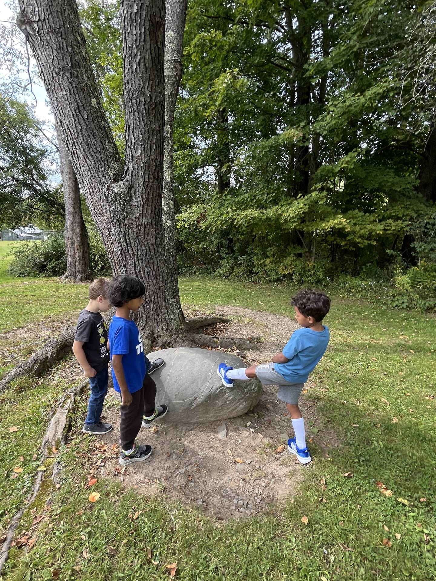 3 students on a rock