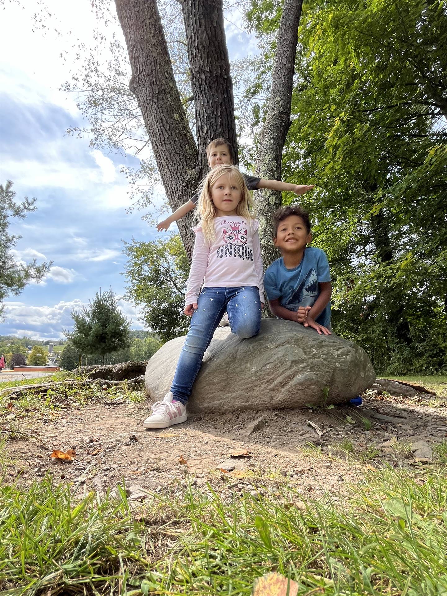 3 students on a rock