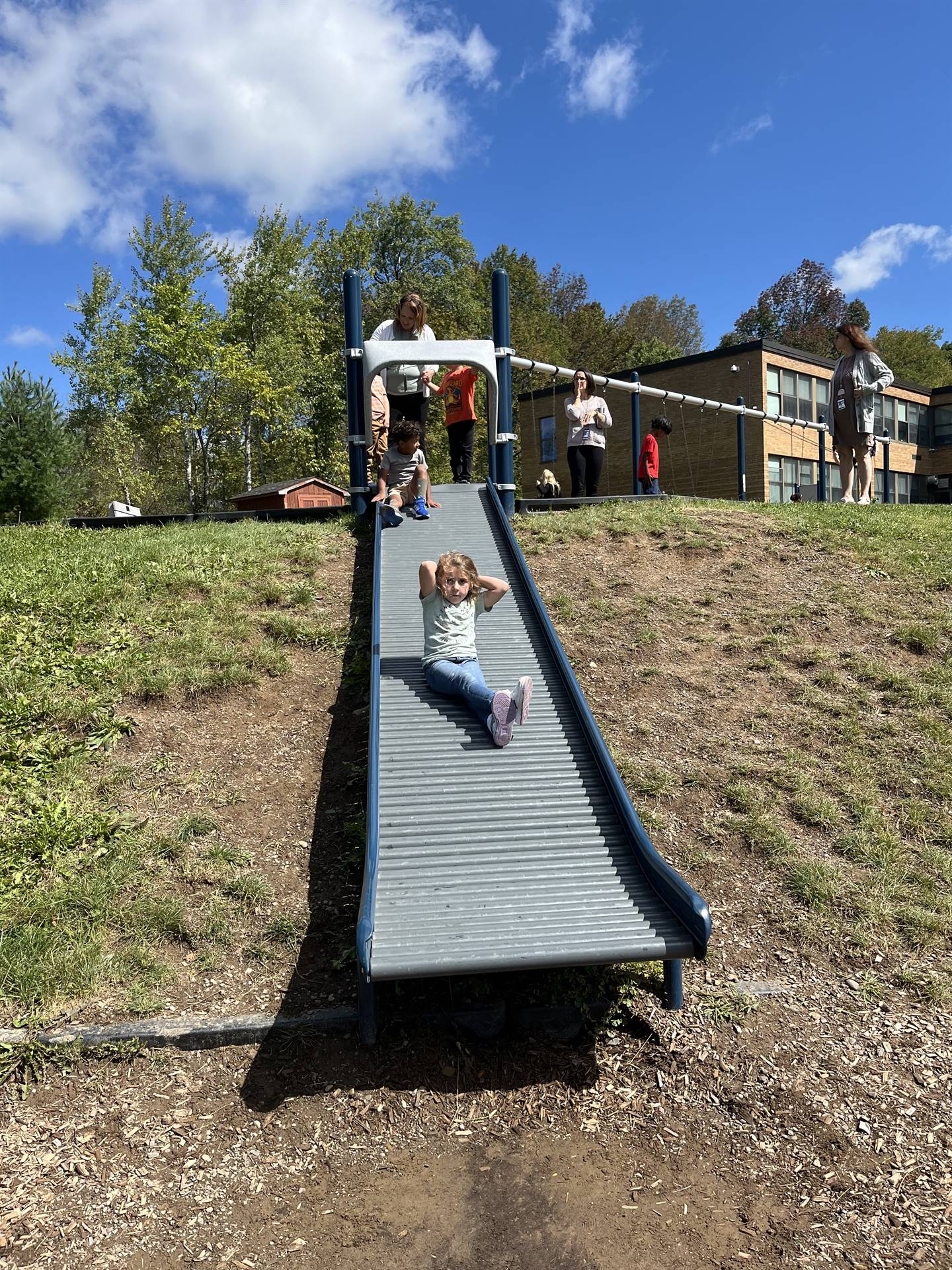 student sliding down a bumpy slide