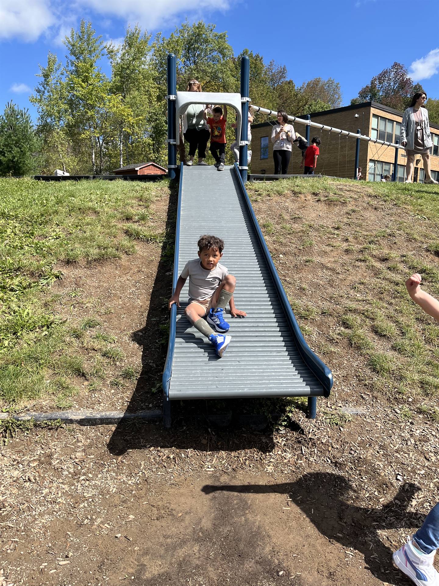 student sliding down a bumpy slide