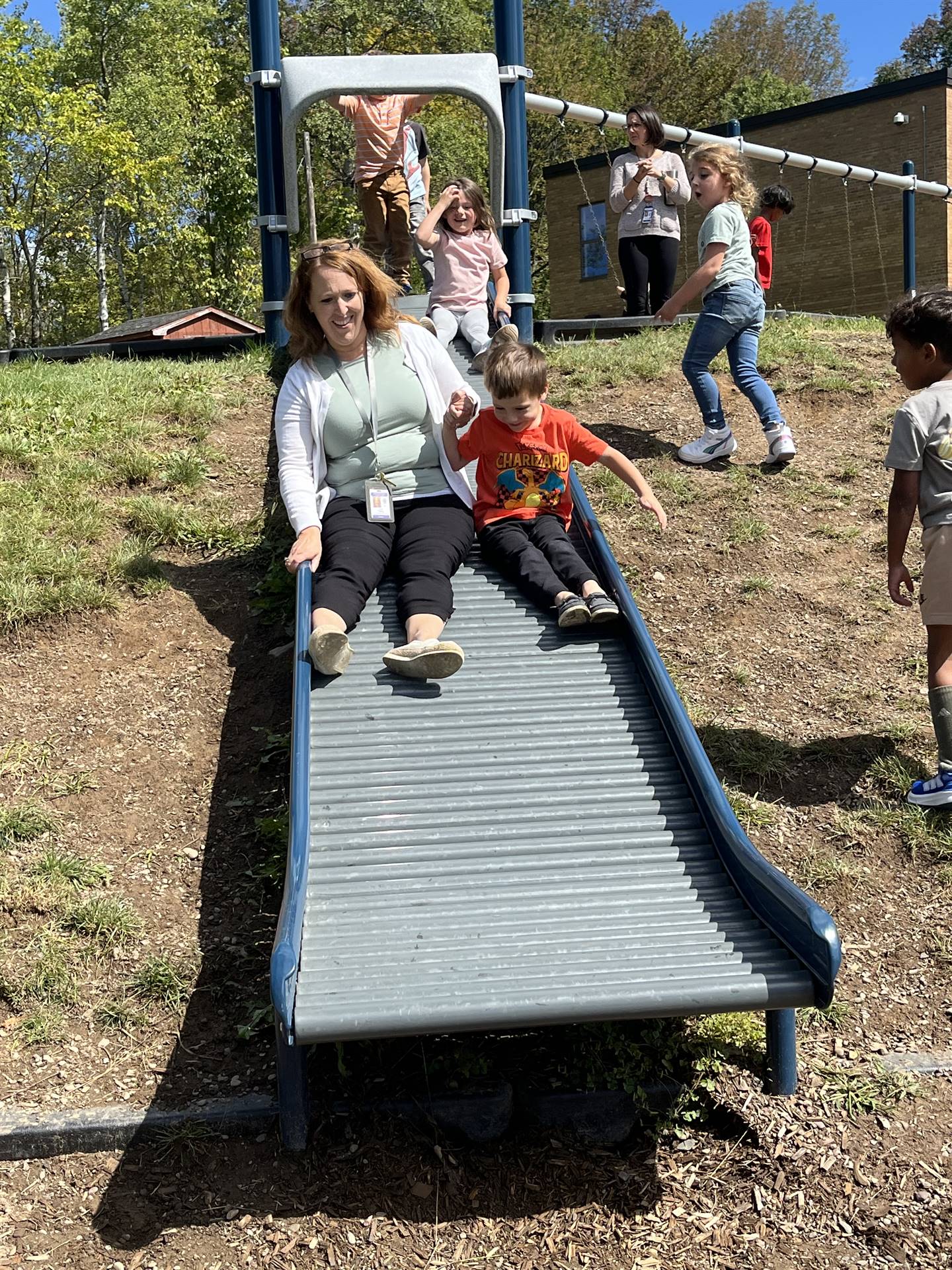 adult and student sliding together