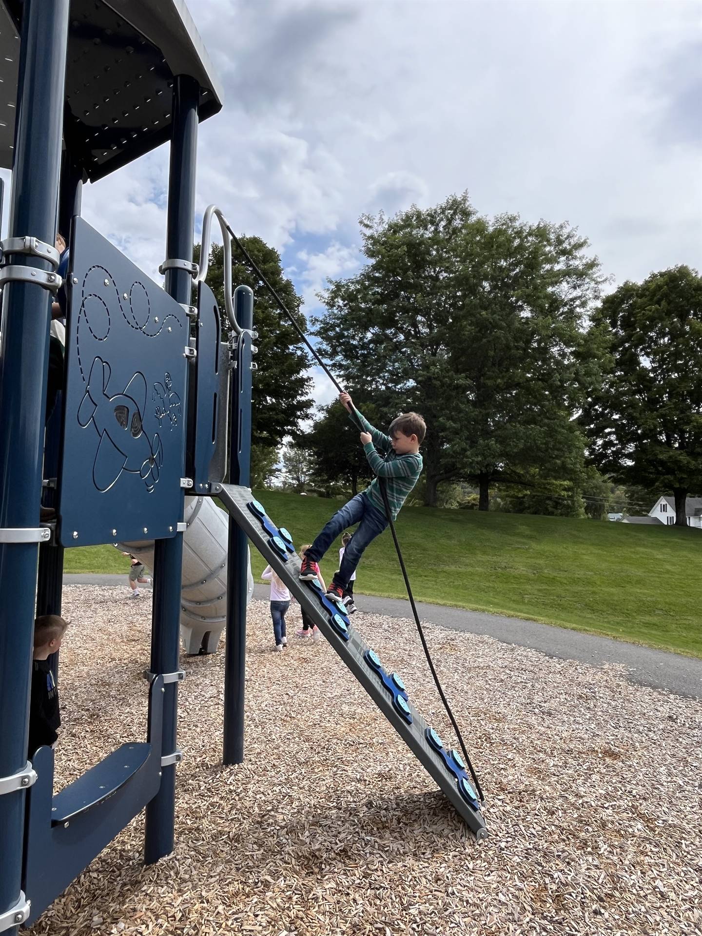 student climbing up a ladder