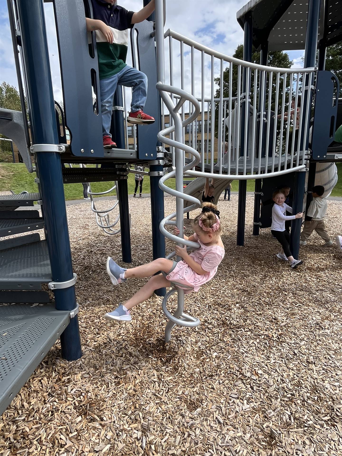 student twirling down a spiral on playground