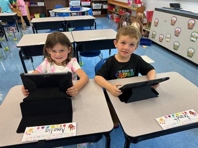 2 students are working on iPads