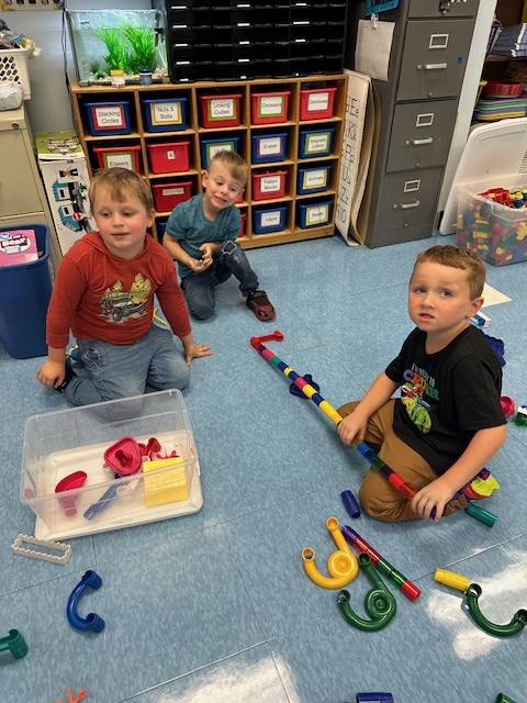 students are building a marble run together