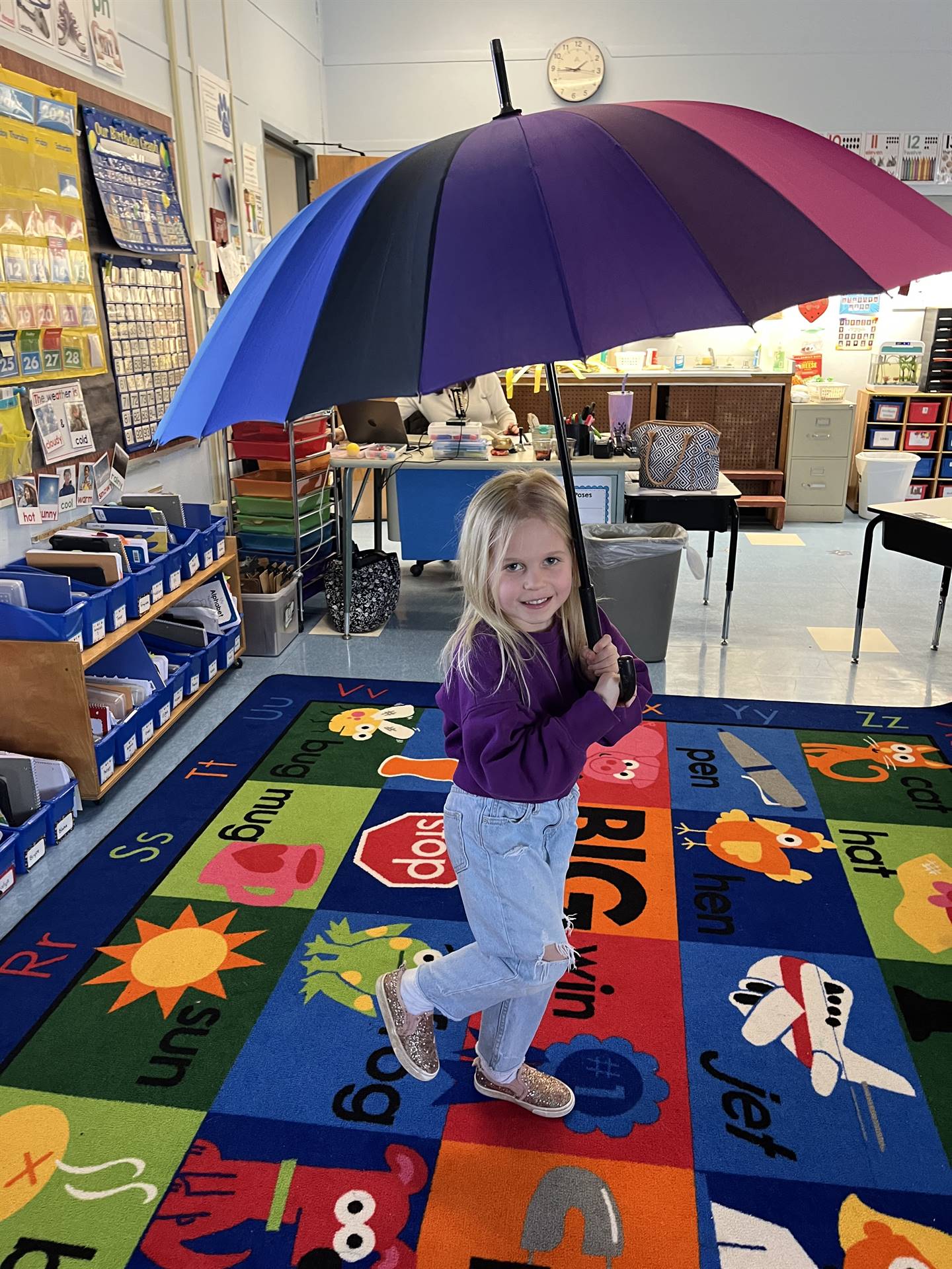student under a rainbow umbrella
