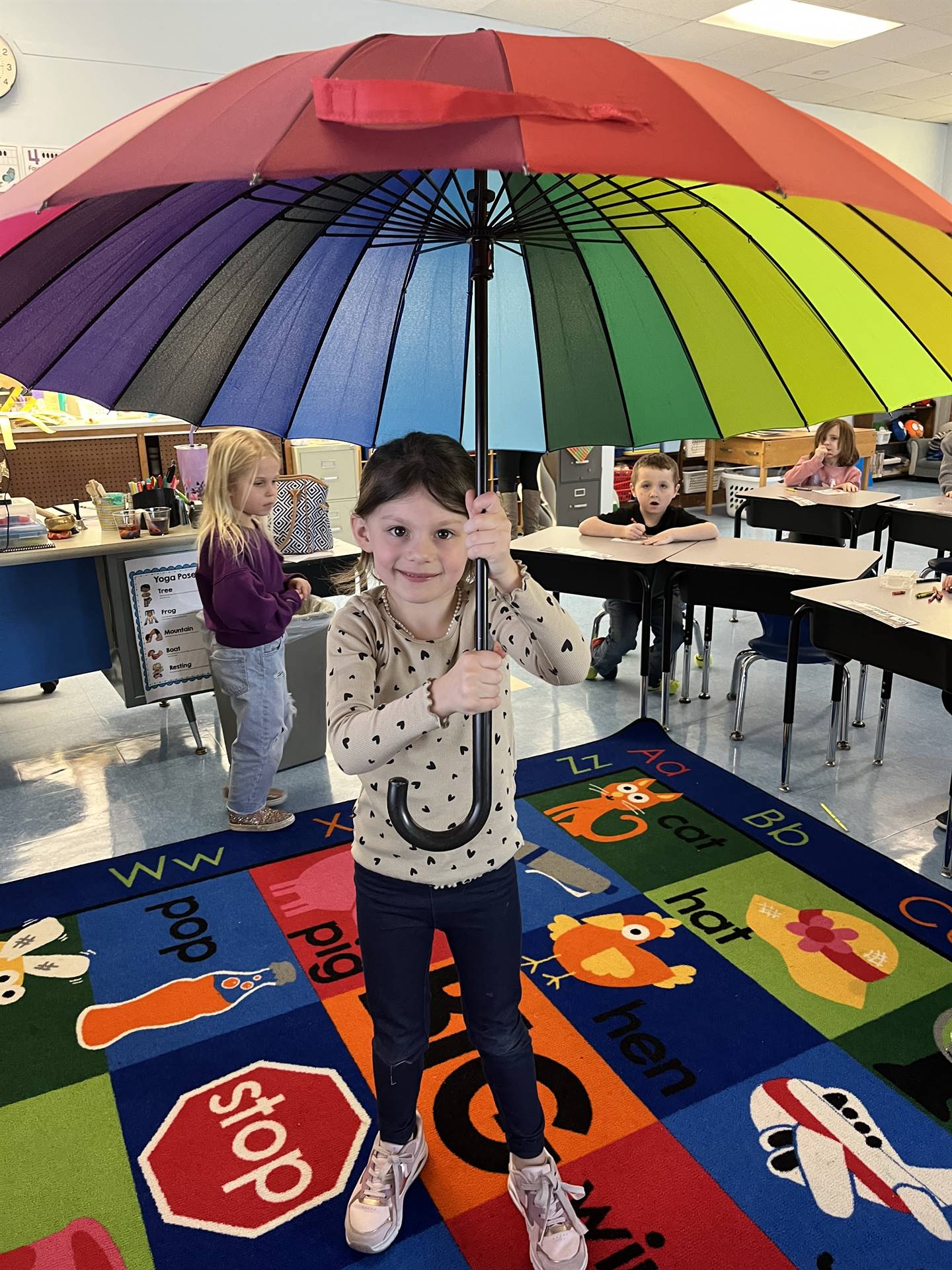 student under a rainbow umbrella