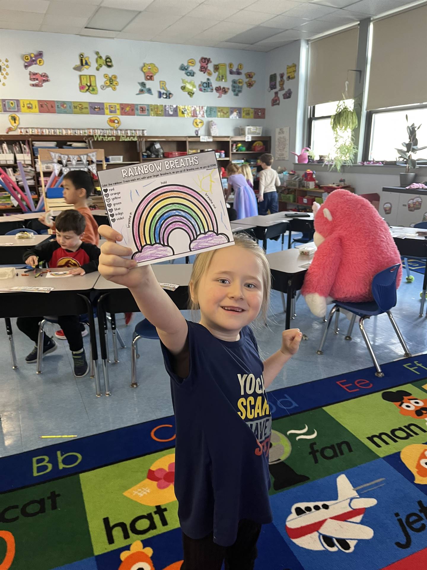A student holds up a colored rainbow breathing guide