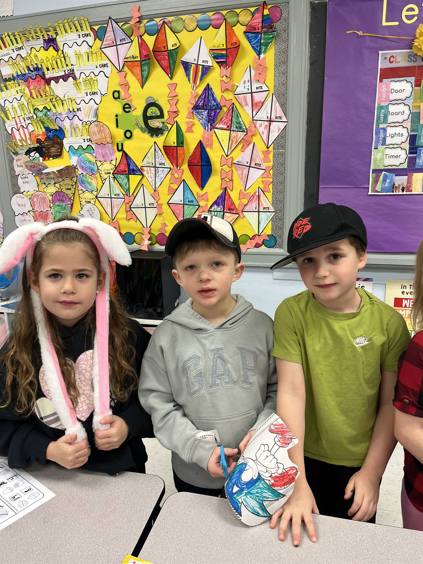 3 student with a different hat on each