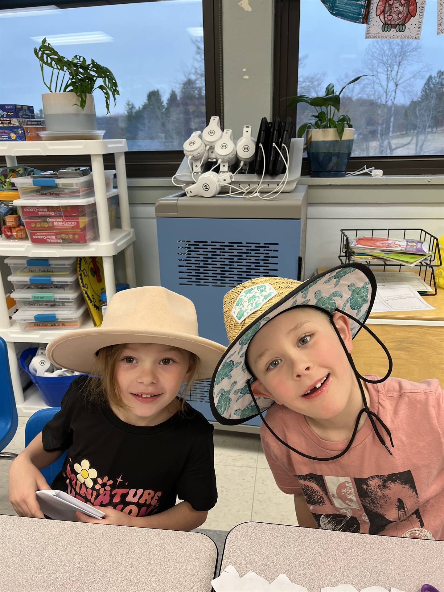 2 students with cowboy/cowgirl hat on each.