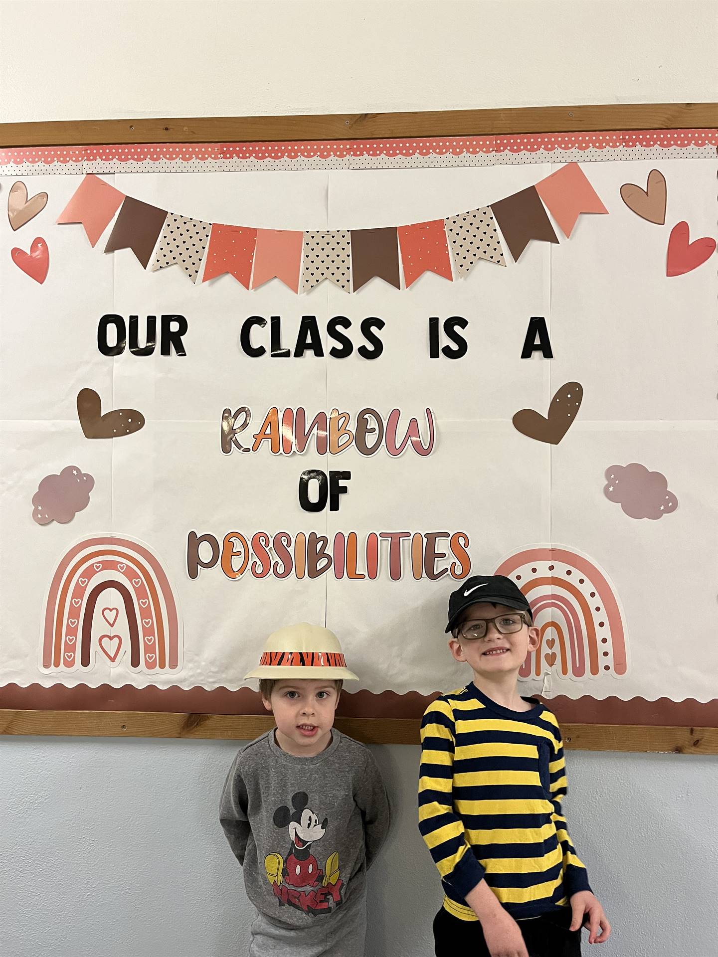 1 student with a ranger hat and another student with a baseball cap.