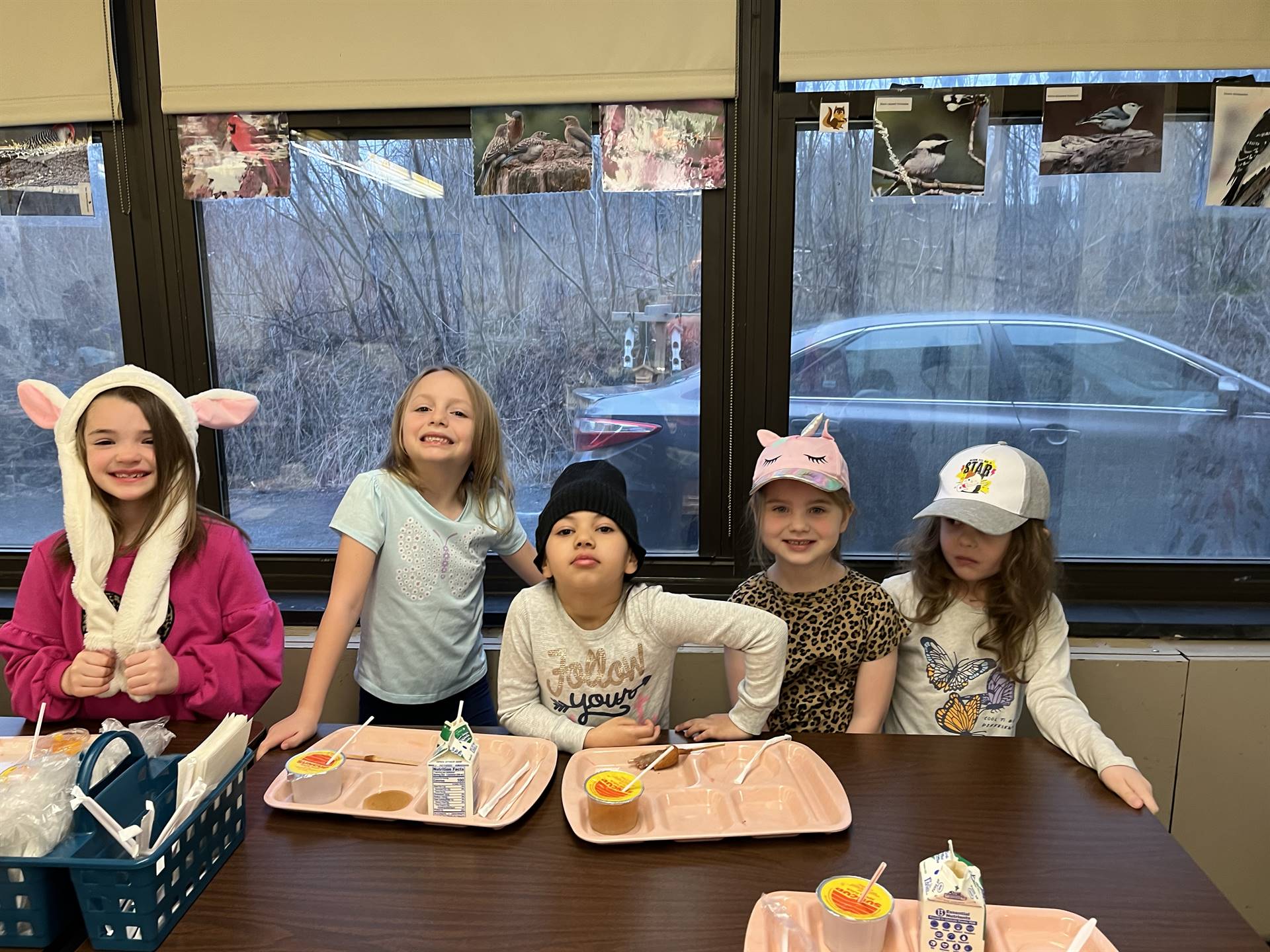 5 students with different hats on their head