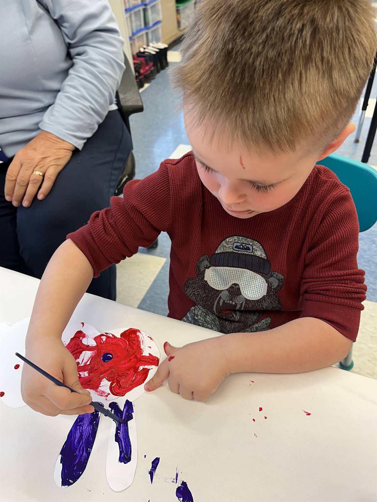 A student paints a blue antenna