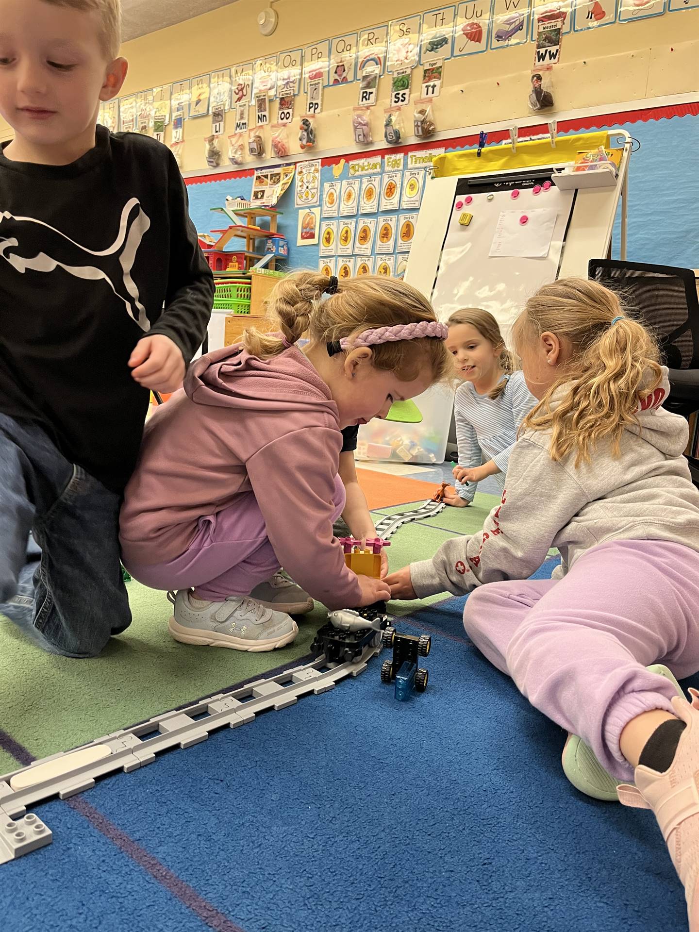 a group of students explore how to set up a robotic train track