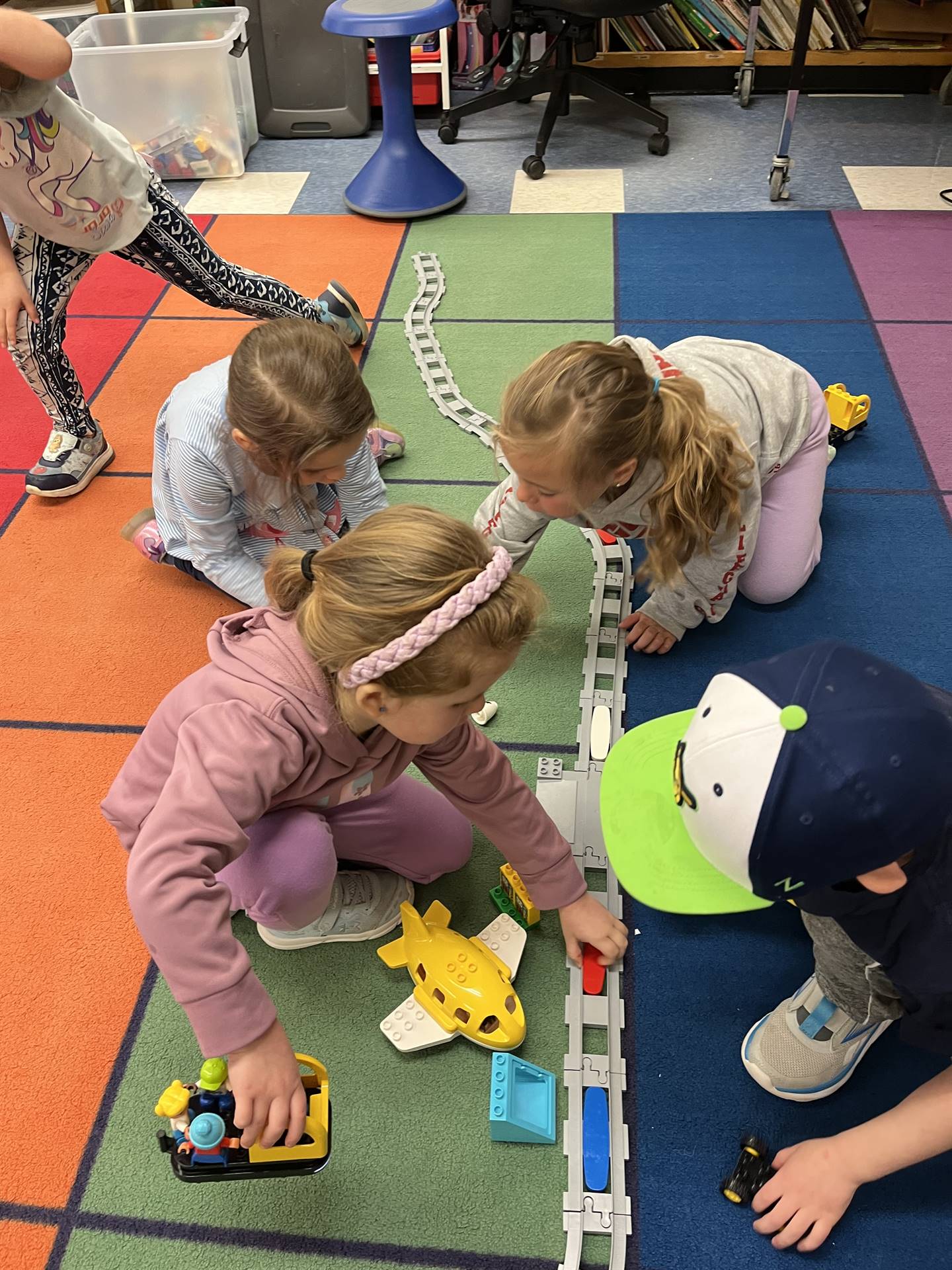 a group of students explore how to set up a robotic train track