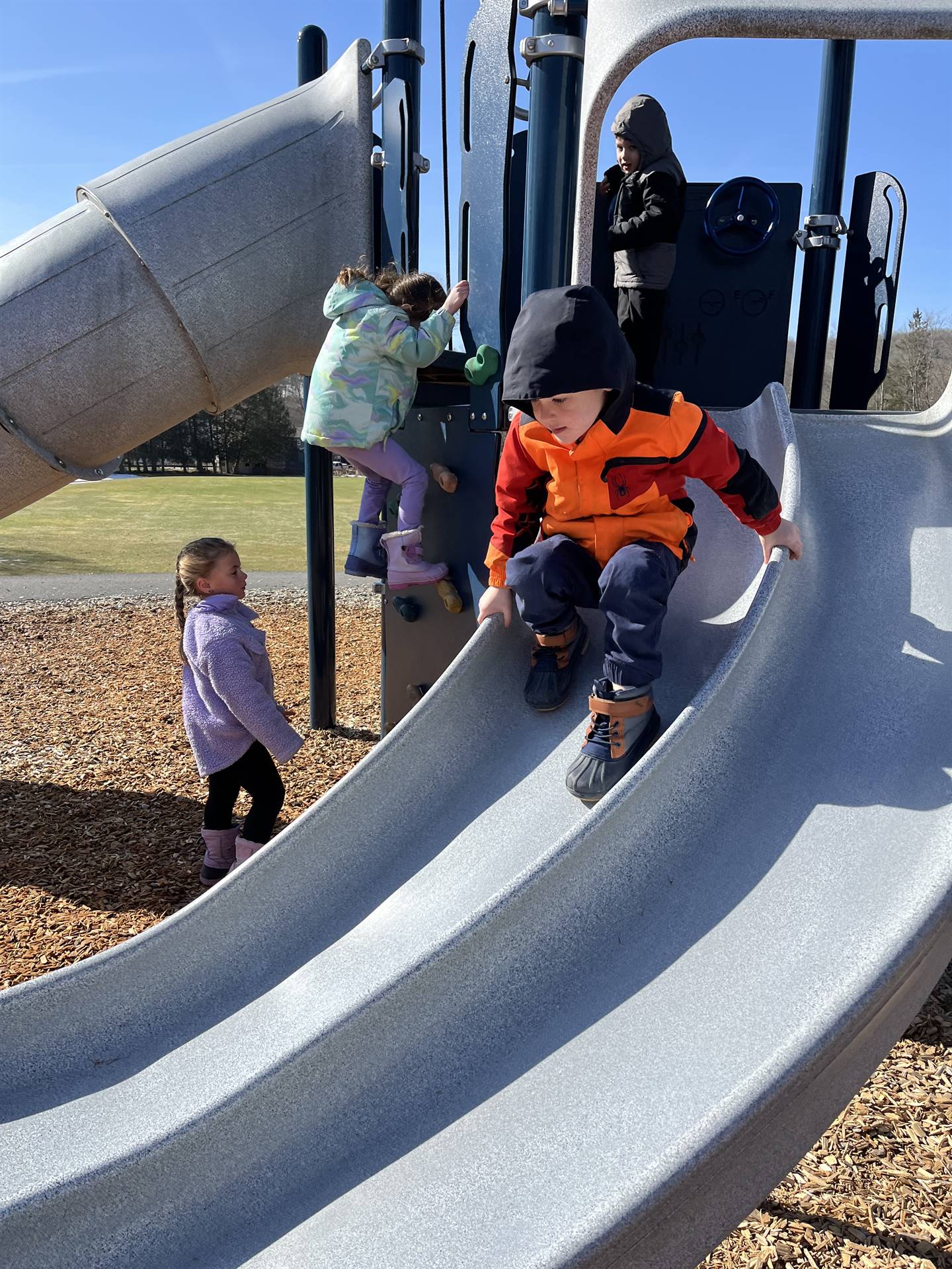 a student slides down slide