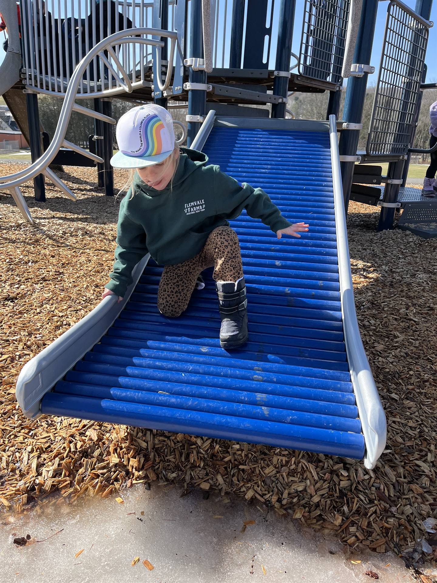 a student going down a roller slide