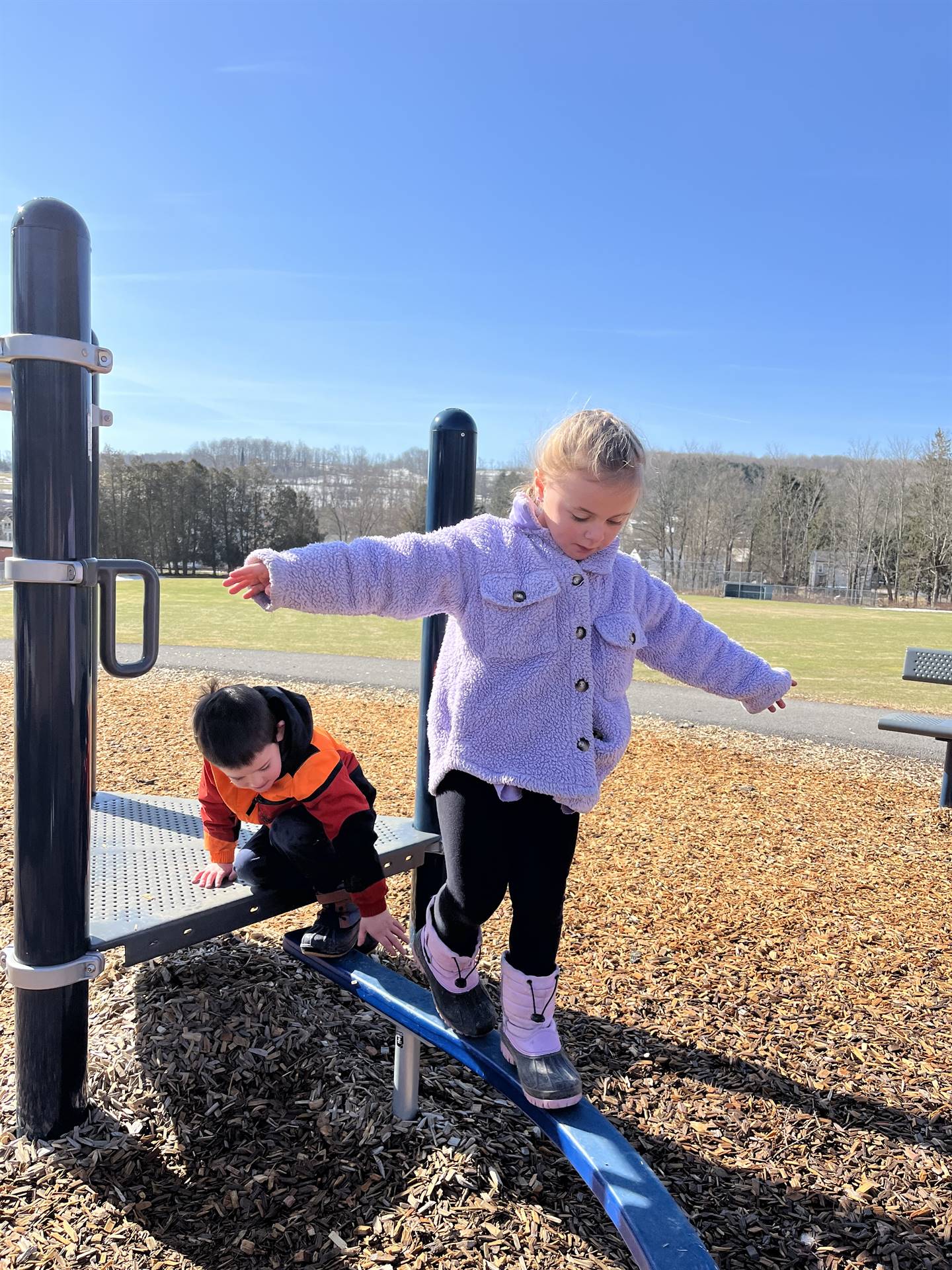 a student on the balance beam outdoors.