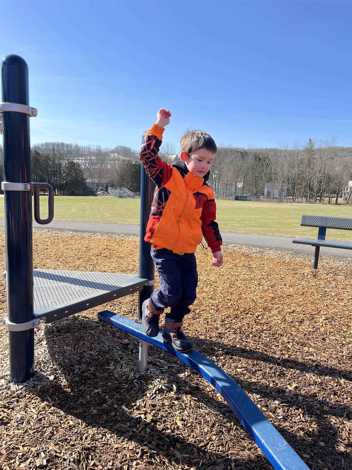 a student on the balance beam outdoors.